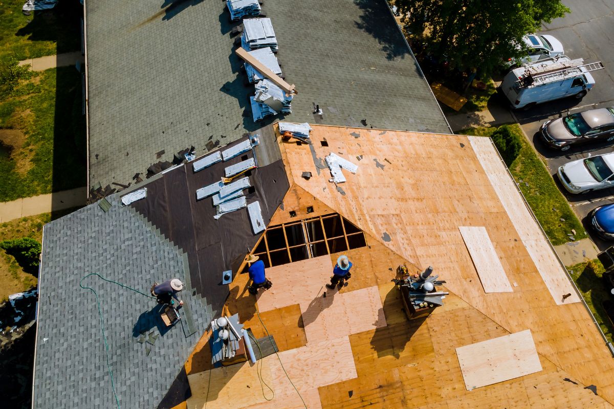 Roofing contractors in Washington DC repairing flashing and drip edge on a residential roof.